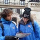 A picture taken of two tour guides wearing our royal blue free tour uniforms in wintertime