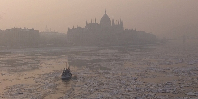 Foggy photo taken during wintertime of the icy river Danube and the Hungarian Parliament building