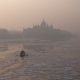 Foggy photo taken during wintertime of the icy river Danube and the Hungarian Parliament building
