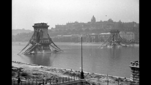 Black and white capture of the iconic Chain bridge blown up at the end of WW2 with the Royal Palace behind