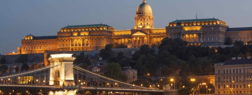 Sunset picture of the Royal Palace in the Castle district of Buda with the Chain bridge in the foreground