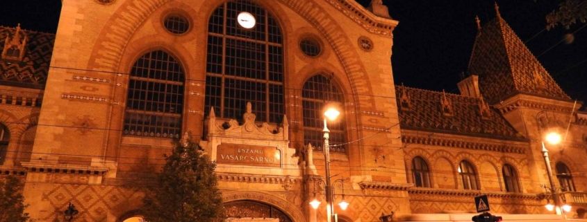 Photo the Central market hall of Budapest at night with an old yellow tram passing by (Evening tour finishes here)