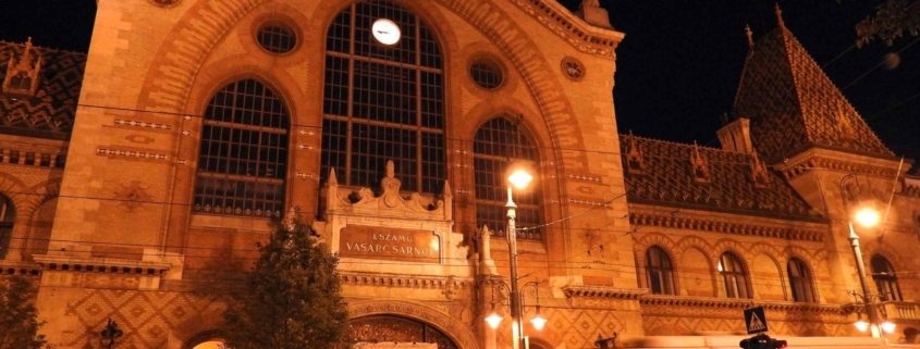 Photo the Central market hall of Budapest at night with an old yellow tram passing by (Evening tour finishes here)