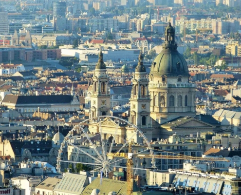 Photo of the city center of Pest with the Saint Stephen's Basilica and the Ferris Wheel in the foreground