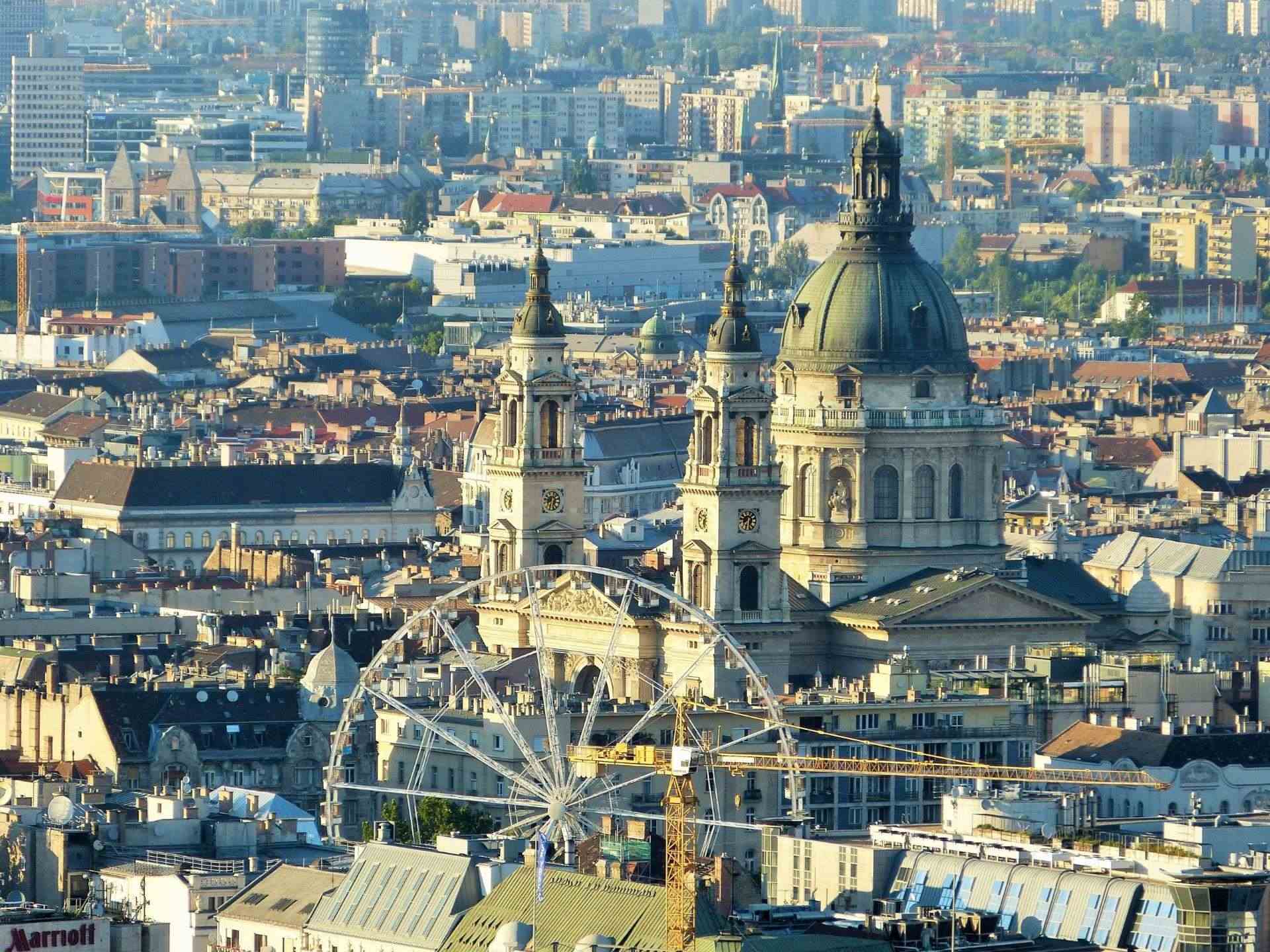 Photo of the city center of Pest with the Saint Stephen's Basilica and the Ferris Wheel in the foreground