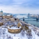 Aerial view of Buda with the Castle district and Pest with the Parliament and the river Danube in wintertime