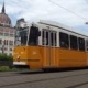 One of the oldschool carts of tram line number 2 in front of the Parliament in Budapest